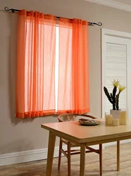 Kitchen design with orange curtains