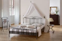 White metal bed in the bedroom interior