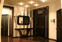 Photo of the hallway in an apartment with dark doors