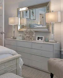 Bedroom design with chest of drawers and mirror photo