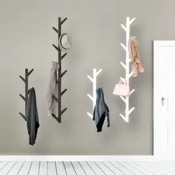 Metal wall hangers for clothes in the hallway photo