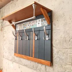 Metal wall hangers for clothes in the hallway photo
