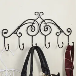 Metal wall hangers for clothes in the hallway photo