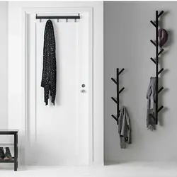 Metal wall hangers for clothes in the hallway photo