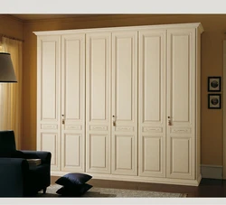 Bedroom wardrobe with hinged doors, light photo