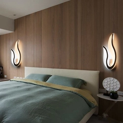 Lamps above the bed in the bedroom interior photo