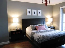 Lamps above the bed in the bedroom interior photo