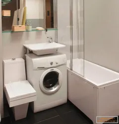 Washing machine in the bathtub under the sink photo