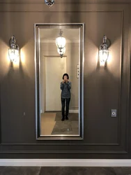 Lamps above the mirror in the hallway in the interior