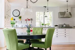 Green chairs in the interior of a white kitchen