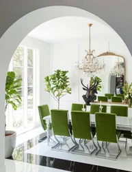 Green chairs in the interior of a white kitchen