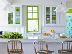Green chairs in the interior of a white kitchen