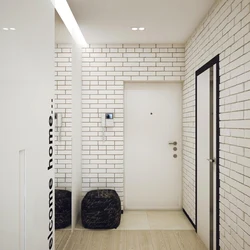 White brick in the interior of the hallway with wallpaper
