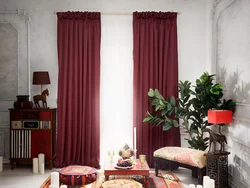 Burgundy curtains in the bedroom interior