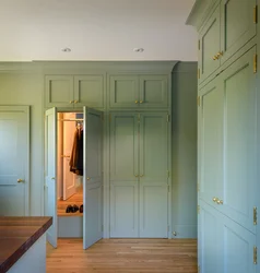 Green wardrobe in the hallway interior