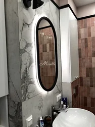 Oval mirror in the bath photo