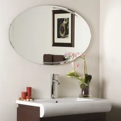 Oval mirror in the bath photo