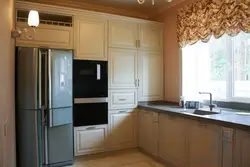 Kitchen on one wall with a refrigerator photo