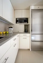 Kitchen on one wall with a refrigerator photo